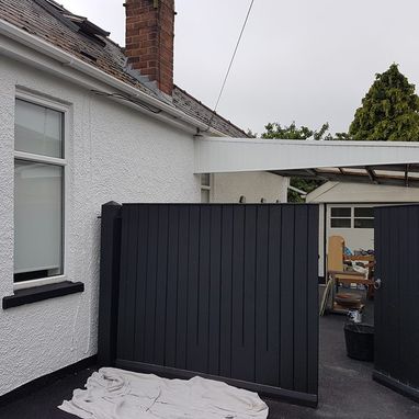 a painted fence in a backyard 
