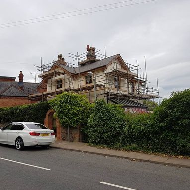 scaffolding around a house ready to be painted 